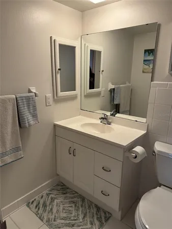a bathroom with a sink toilet and mirror
