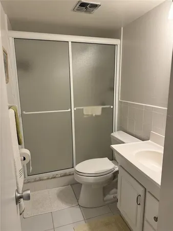 a bathroom with a sink a toilet and a shower