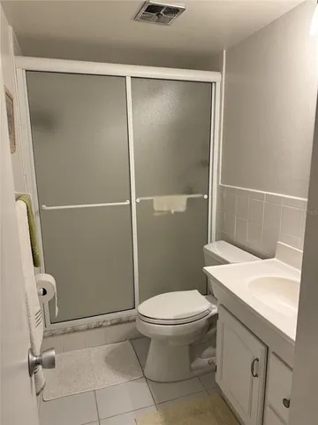 a bathroom with a sink a toilet and a shower