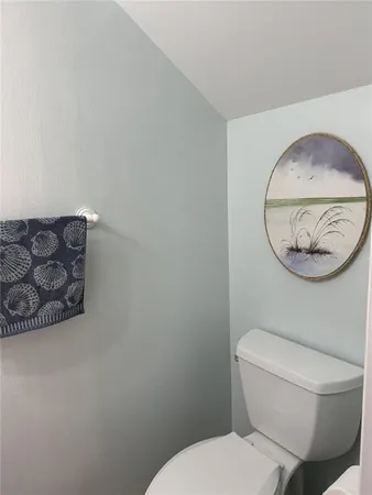 a bathroom with a toilet and a mirror