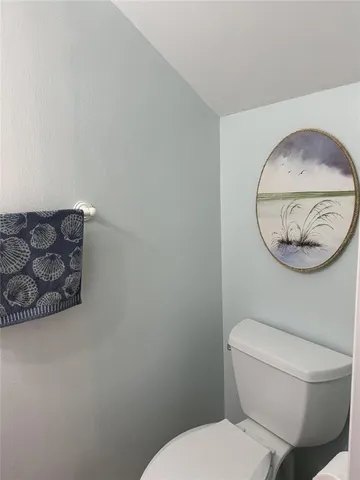 a bathroom with a toilet and a mirror