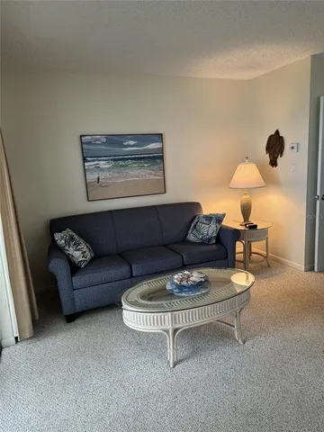 a living room with furniture and a lamp