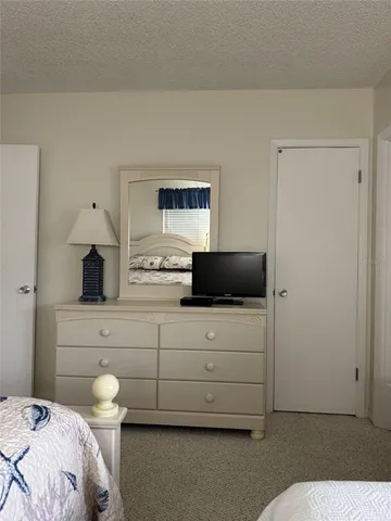 a bedroom with a bed and a tv