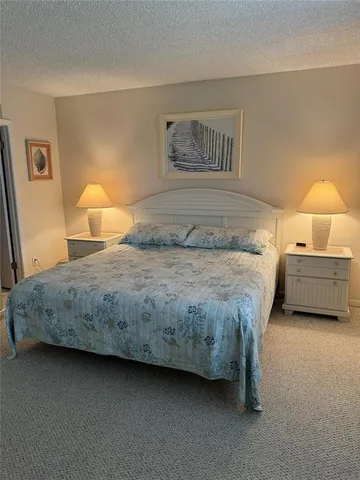 a bedroom with a bed and lamp