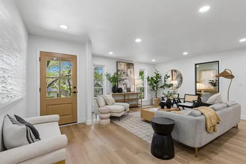 a living room with furniture and a large window