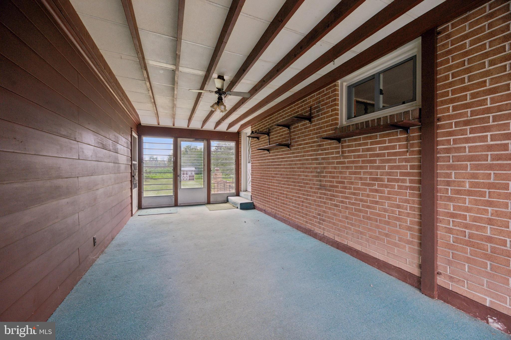 2518 Rhoads Road Gilbertsville, PA 19525 - Photo 6 of 20 Inviting sunroom with exposed brick