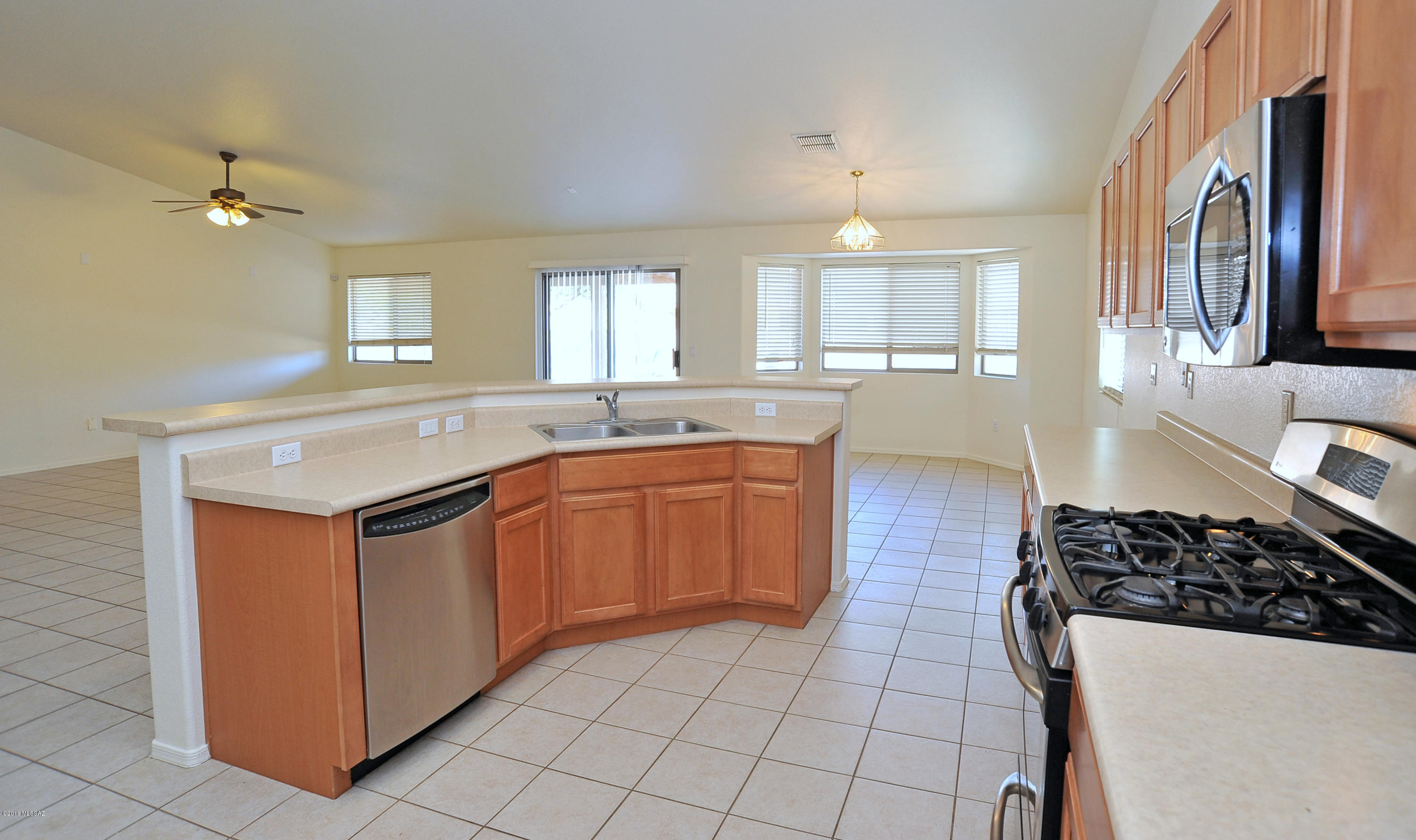 558 West Chatfield Street Vail, AZ 85641 - Photo 8 of 31 a kitchen with a sink stove and cabinets