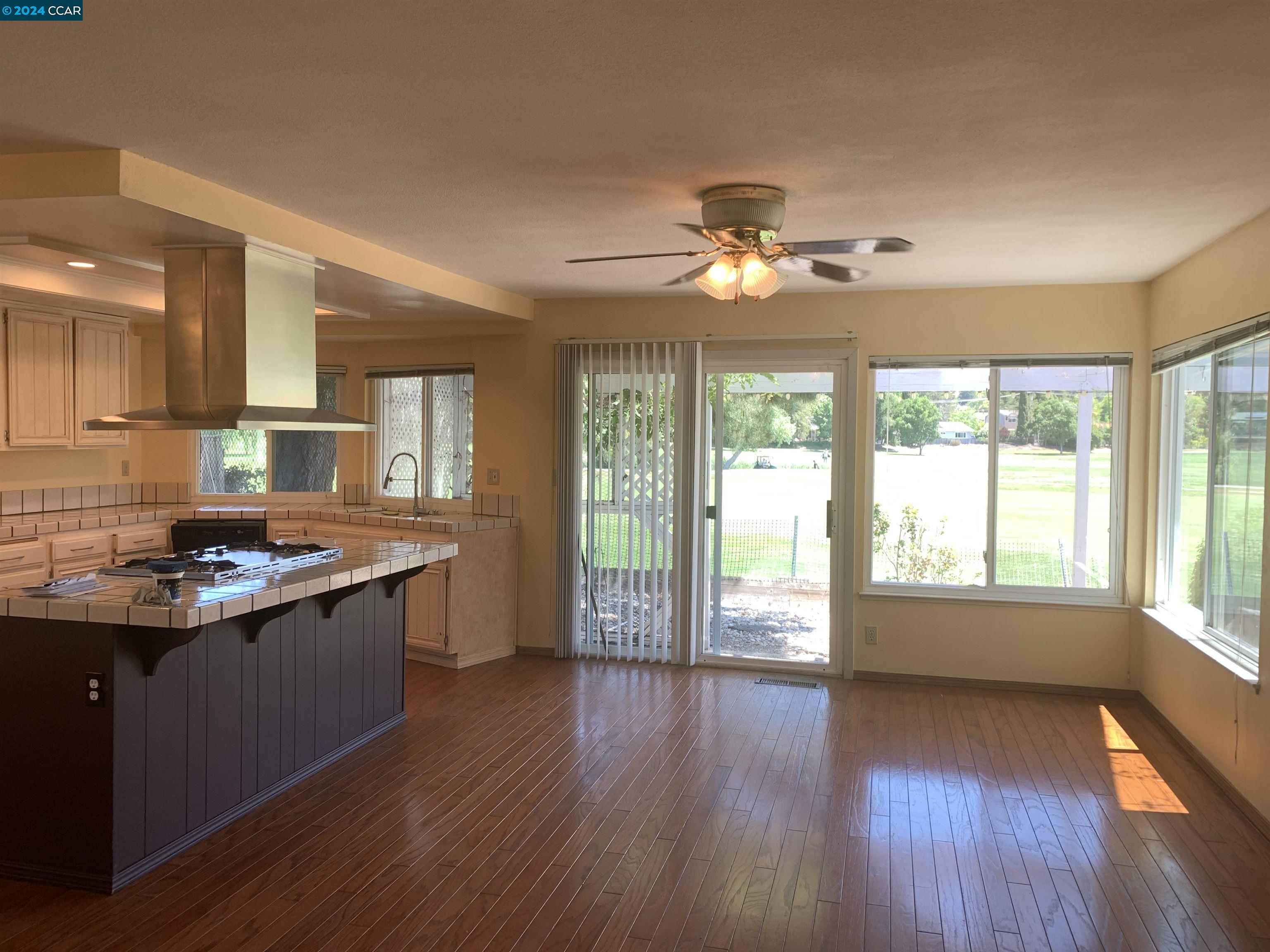 9462 Thunderbird Place San Ramon, CA 94583 - Photo 13 of 17 a view of a kitchen counter space wooden floor and a ceiling fan