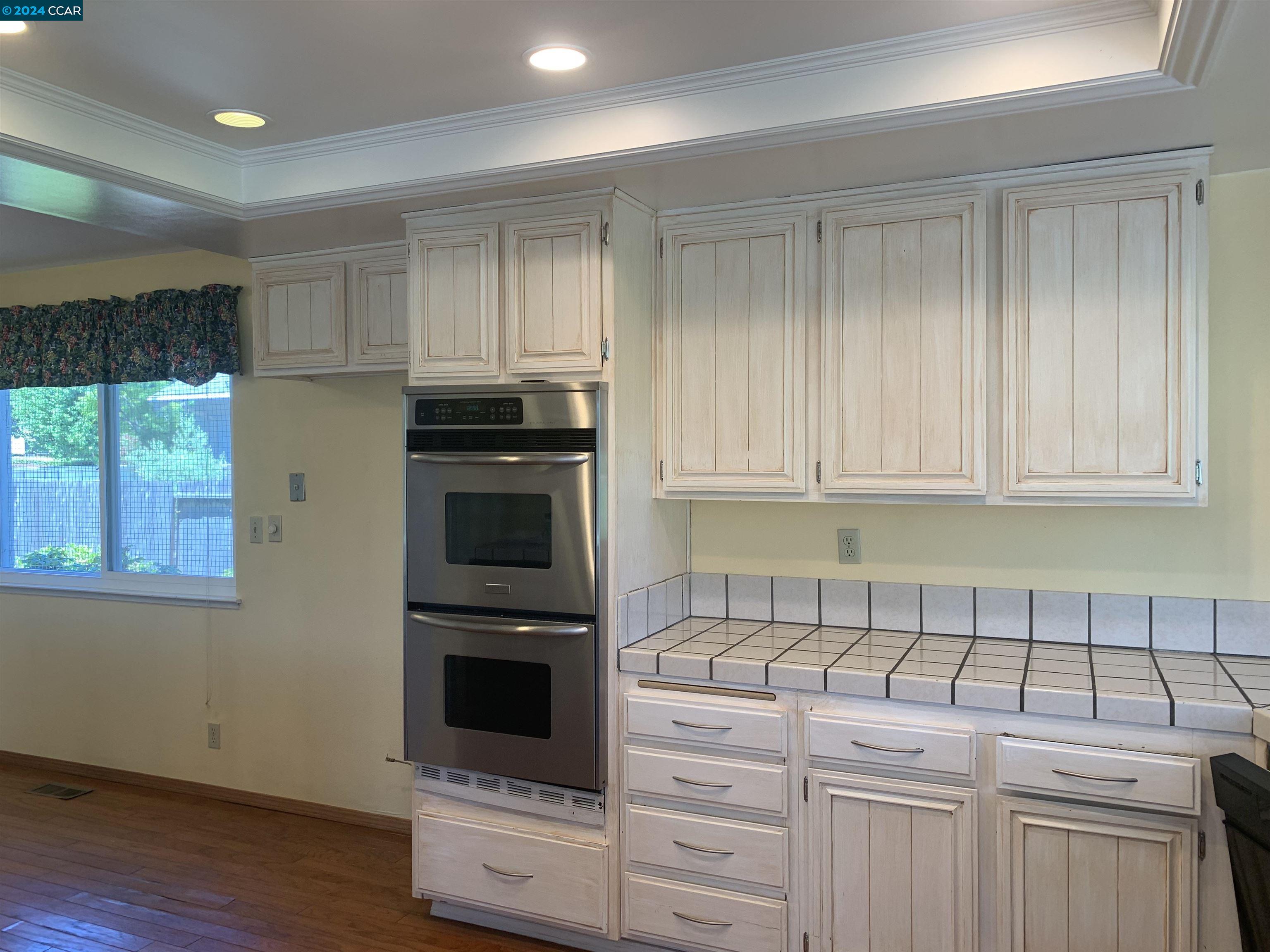 9462 Thunderbird Place San Ramon, CA 94583 - Photo 17 of 17 a kitchen with granite countertop a stove a sink and a microwave