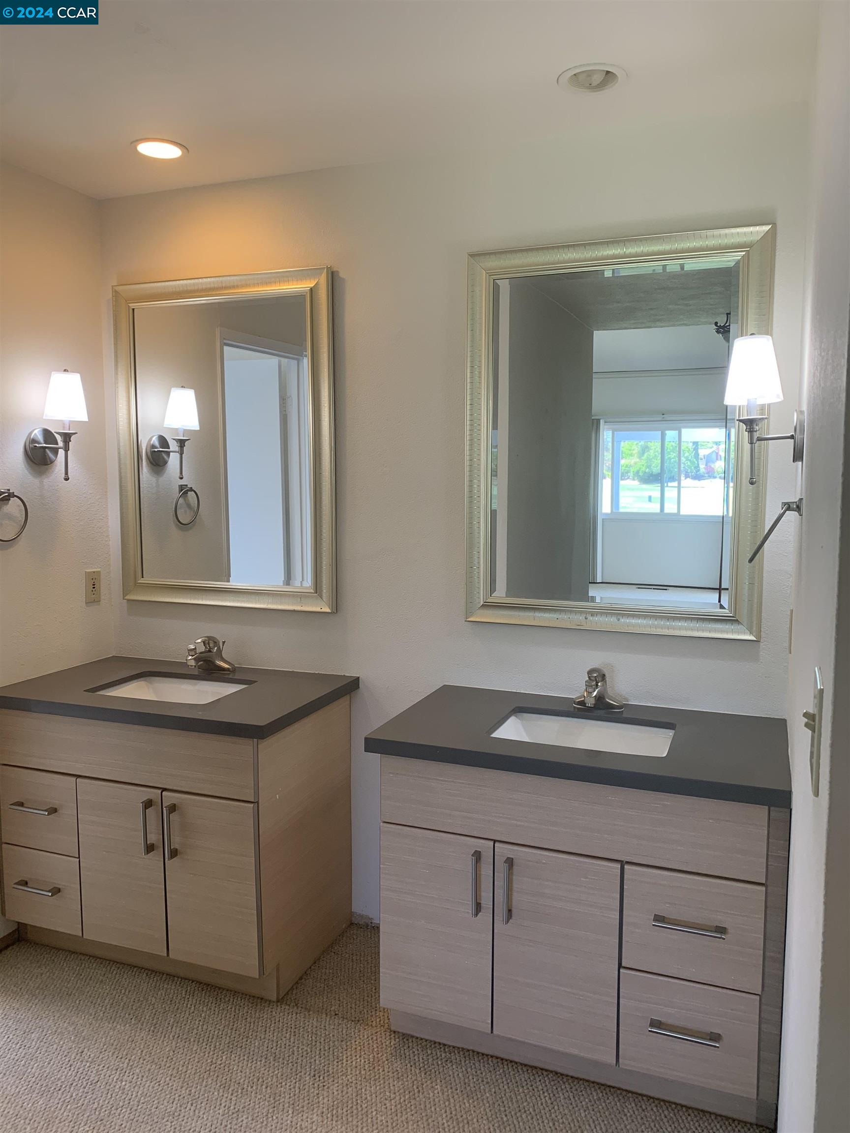 9462 Thunderbird Place San Ramon, CA 94583 - Photo 7 of 17 a bathroom with a granite countertop sink double and mirror