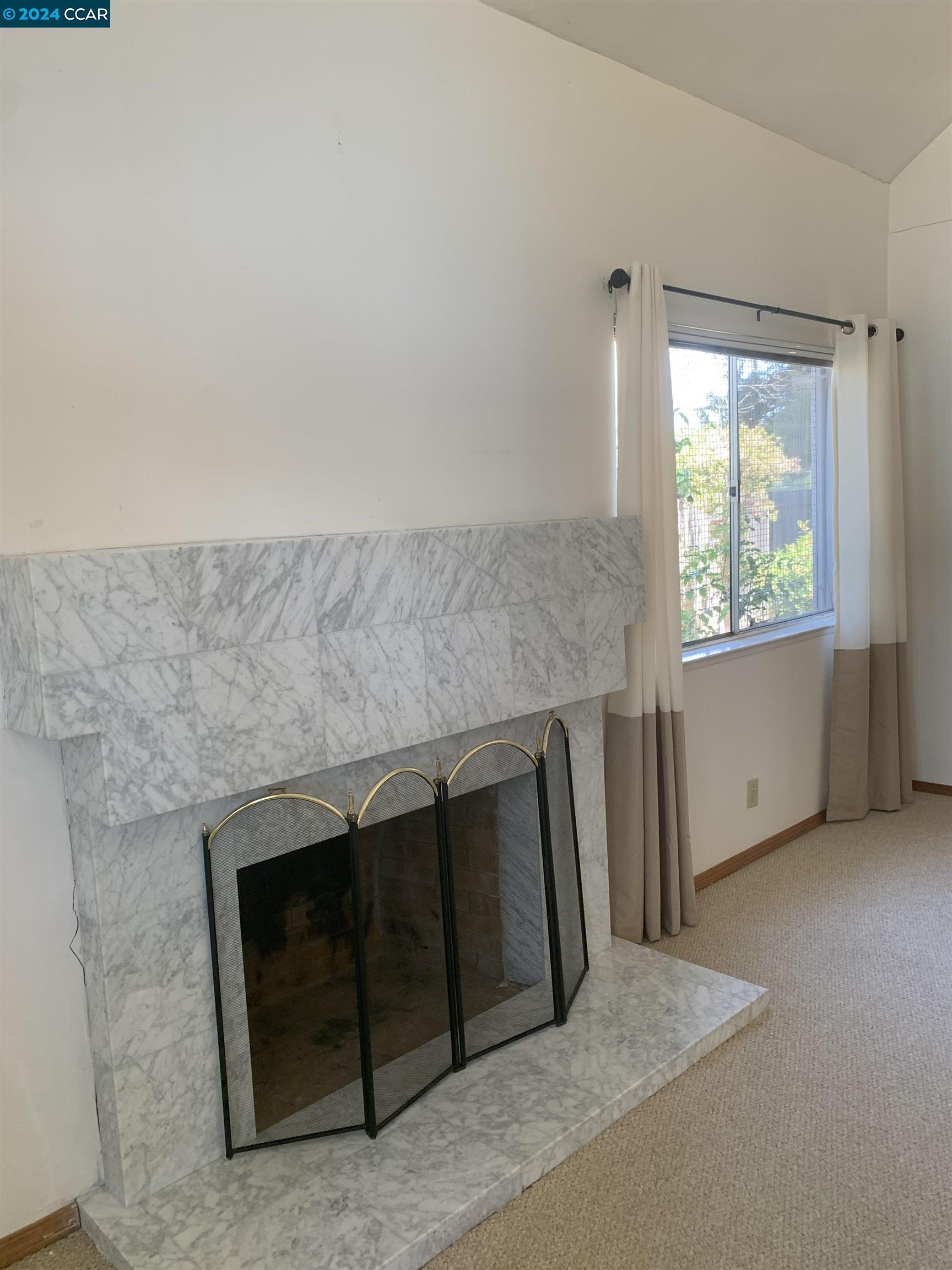 9462 Thunderbird Place San Ramon, CA 94583 - Photo 10 of 17 a living room with a fireplace and a window