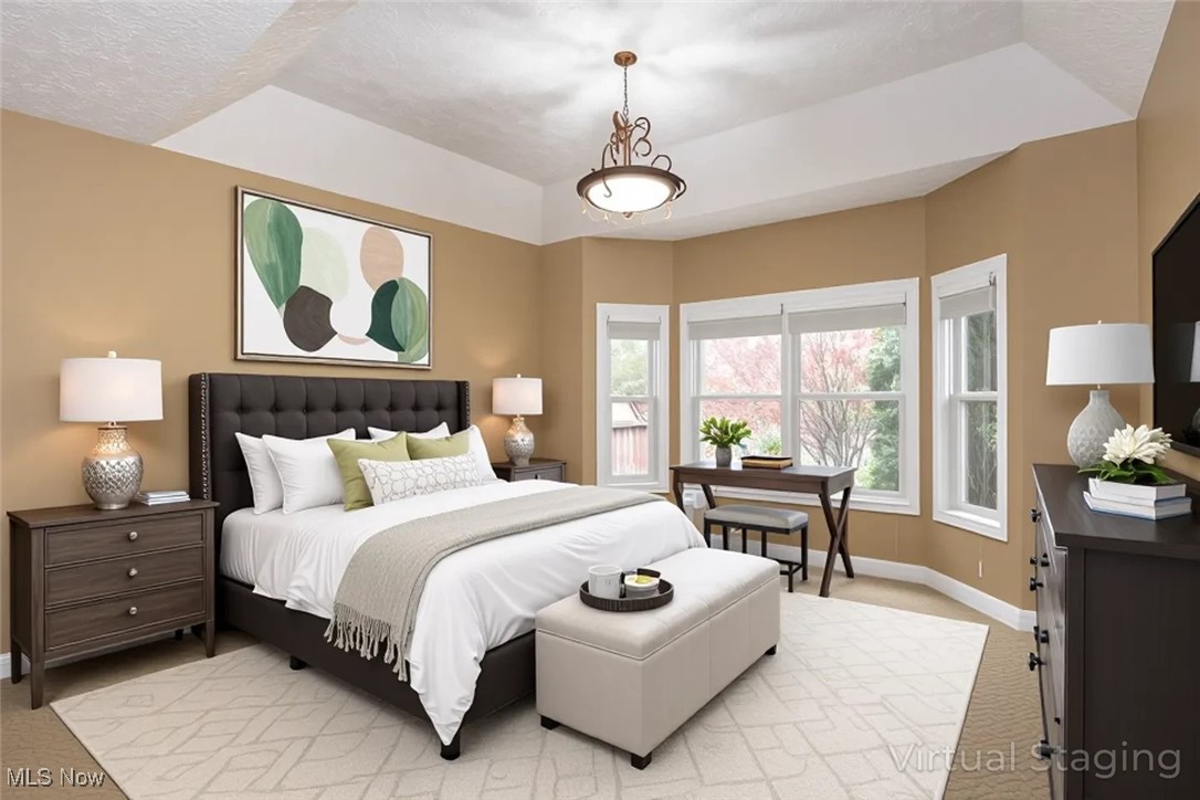 630 Rundle Street Lagrange, OH 44050 - Photo 17 of 49 Bedroom featuring light colored carpet, a textured ceiling, and a raised ceiling
