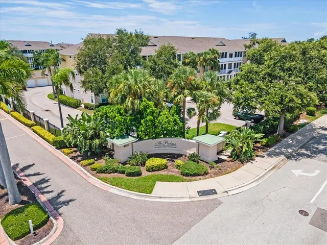 an aerial view of residential houses with outdoor space and swimming pool