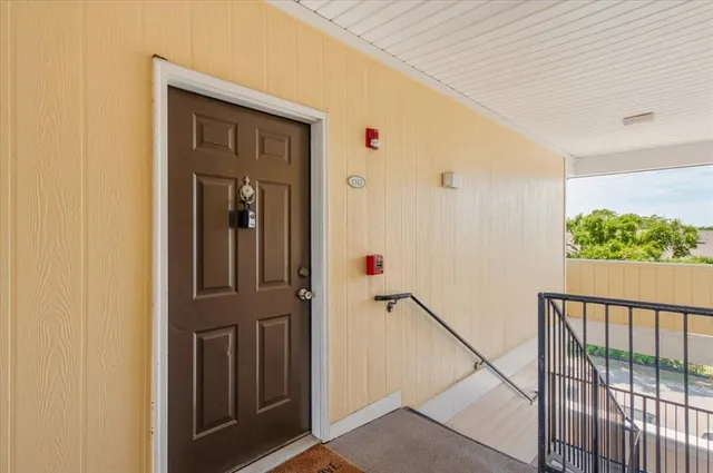 an aerial view of a house with a yard and lake view