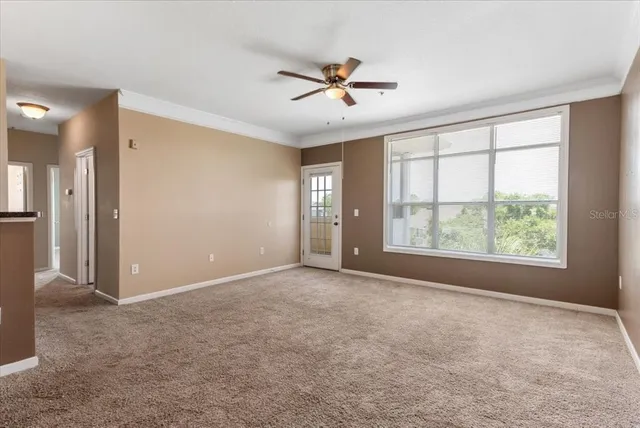 a view of a livingroom with a ceiling fan and window