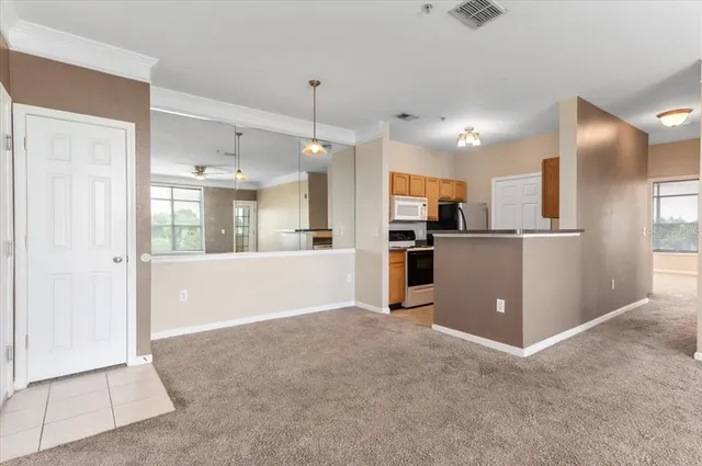 a view of an empty room with window and cabinet
