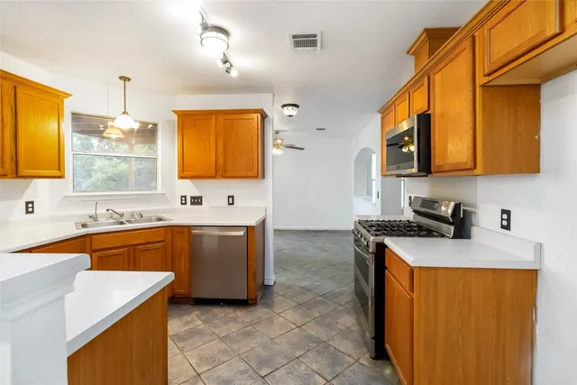a kitchen with stainless steel appliances granite countertop sink stove and granite counter top