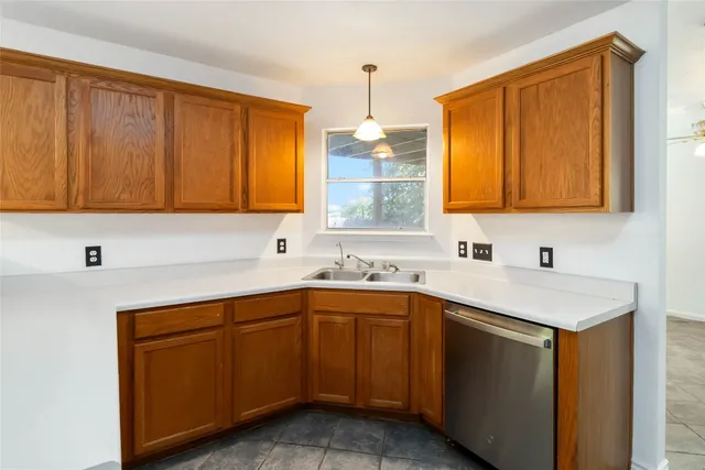 a kitchen with a sink stove and cabinets