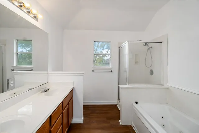 a bathroom with a tub sink and mirror