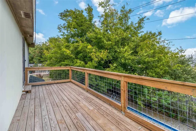 a view of balcony with wooden floor