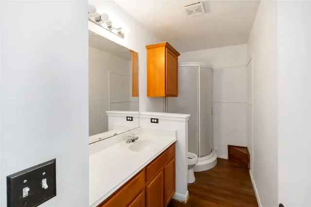 a bathroom with a sink a toilet and mirror
