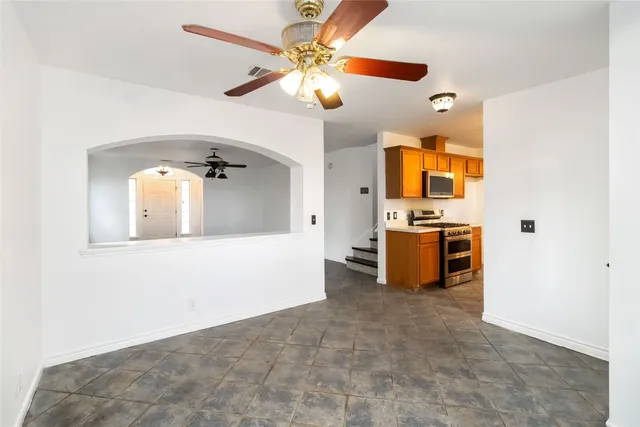 a view of a kitchen with a sink and a refrigerator