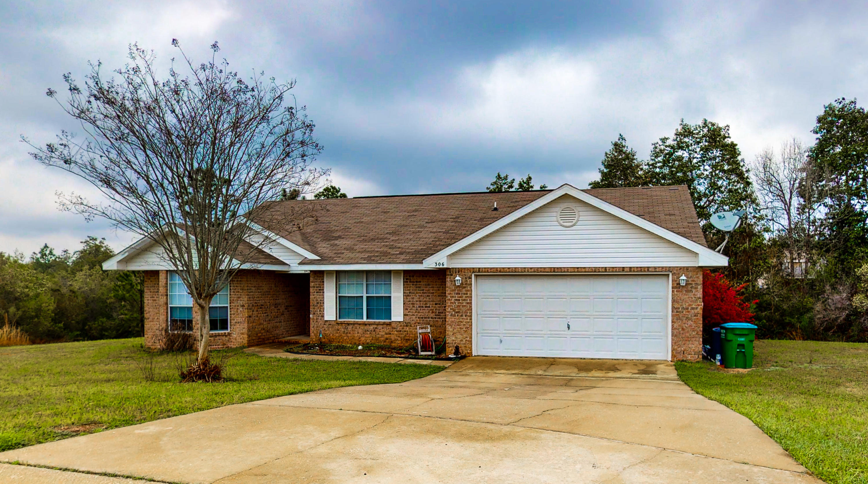 306 Shield Drive Crestview, FL 32539 - Photo 1 of 34 a front view of a house with a yard and garage