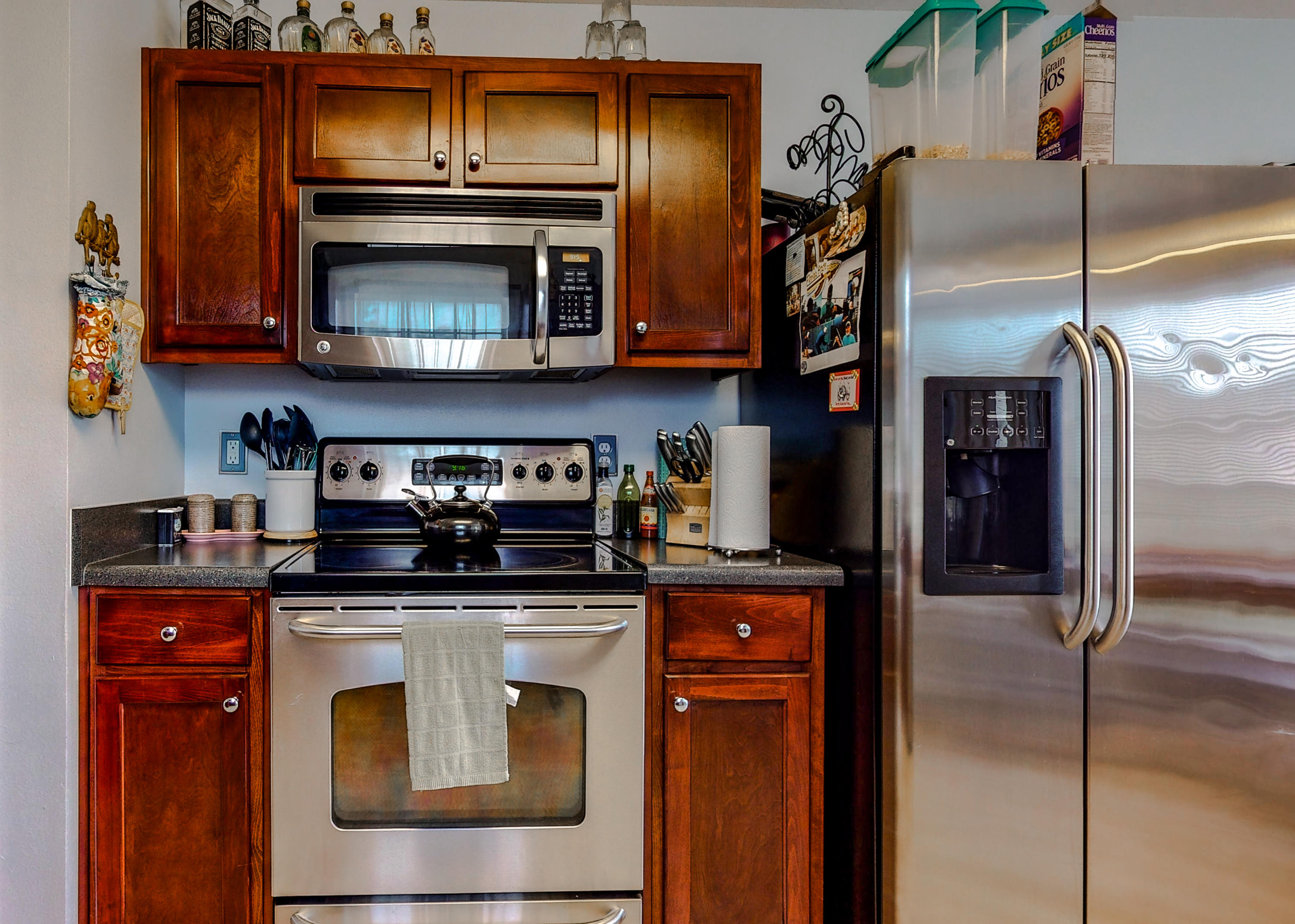 306 Shield Drive Crestview, FL 32539 - Photo 14 of 34 a kitchen with stainless steel appliances granite countertop a stove top oven microwave and refrigerator