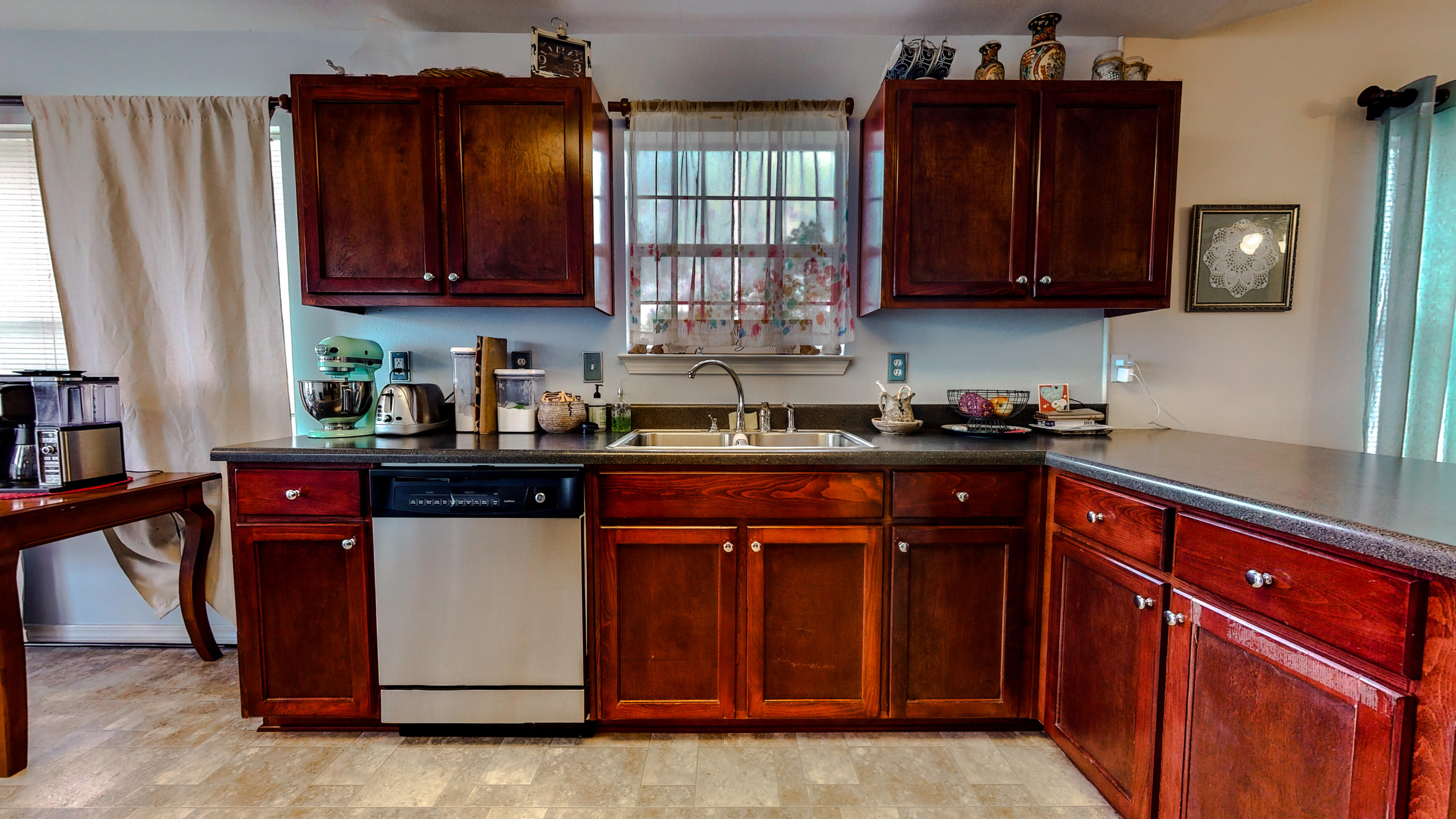 306 Shield Drive Crestview, FL 32539 - Photo 15 of 34 a kitchen with stainless steel appliances granite countertop wooden cabinets a stove top oven a sink and dishwasher