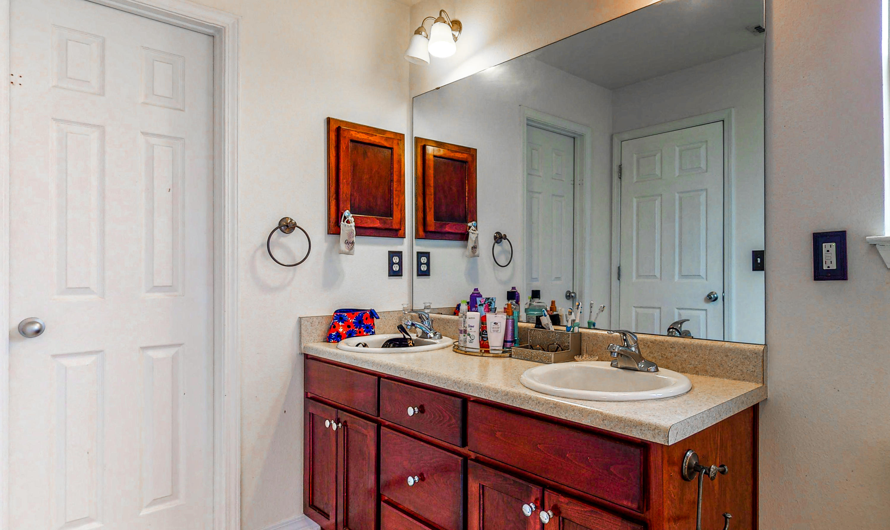 306 Shield Drive Crestview, FL 32539 - Photo 23 of 34 a bathroom with a sink and a mirror
