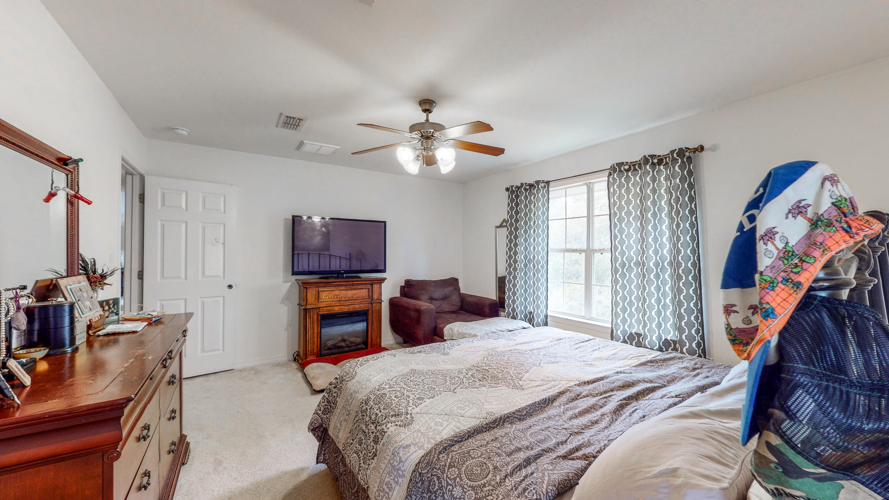 306 Shield Drive Crestview, FL 32539 - Photo 26 of 34 a bedroom with a bed and a chandelier