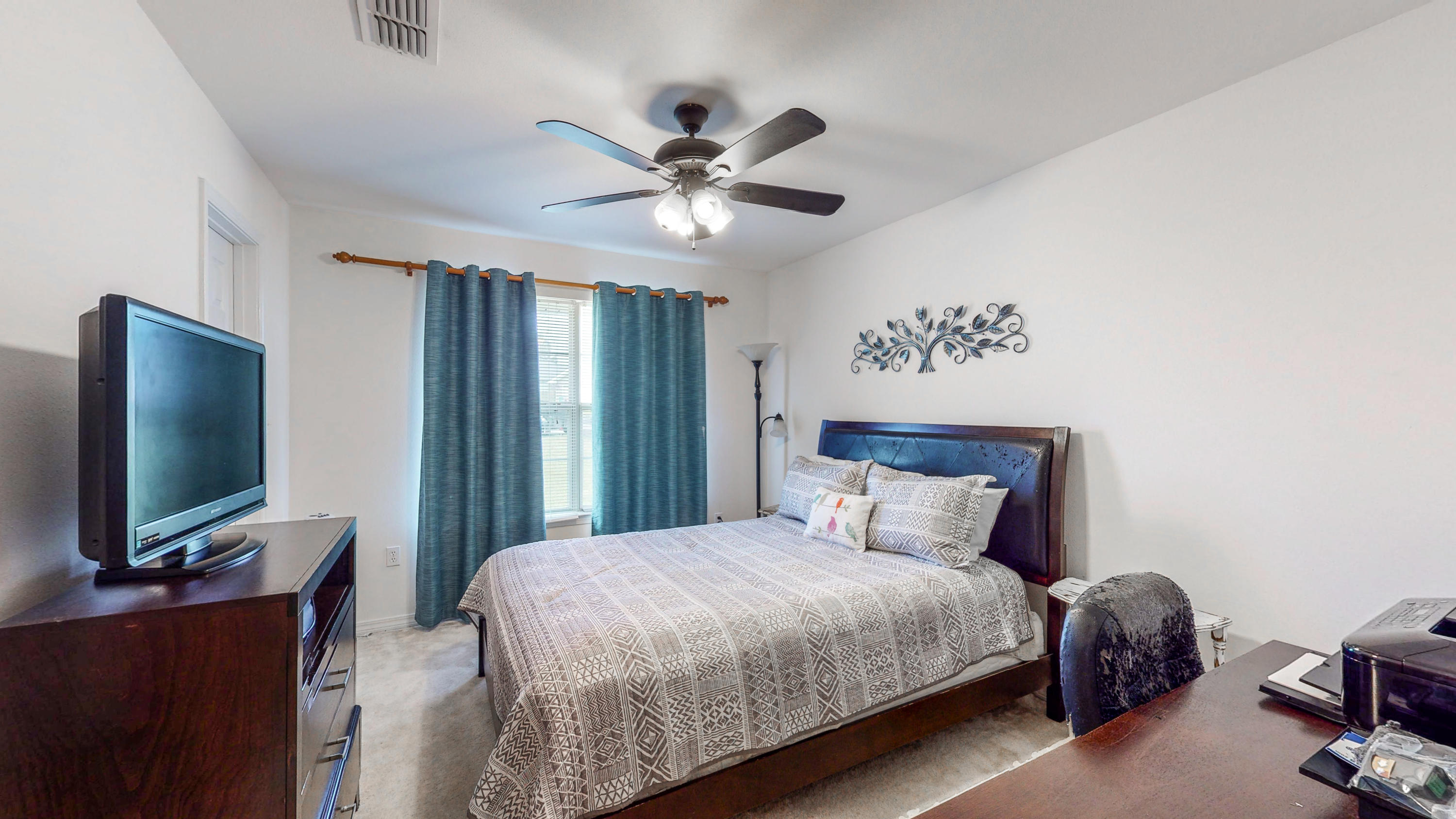 306 Shield Drive Crestview, FL 32539 - Photo 30 of 34 a bedroom with a bed and a flat tv screen on dresser