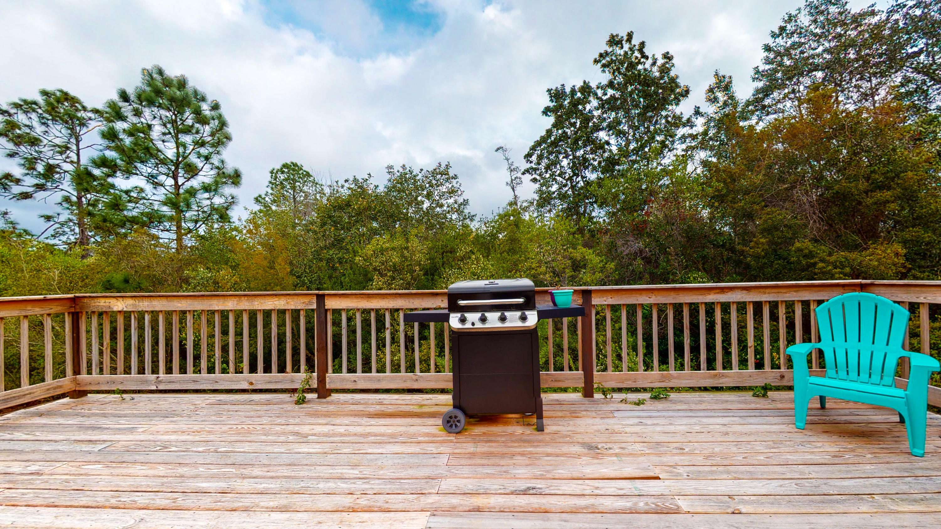 306 Shield Drive Crestview, FL 32539 - Photo 4 of 34 a view of a balcony with wooden floor and fence