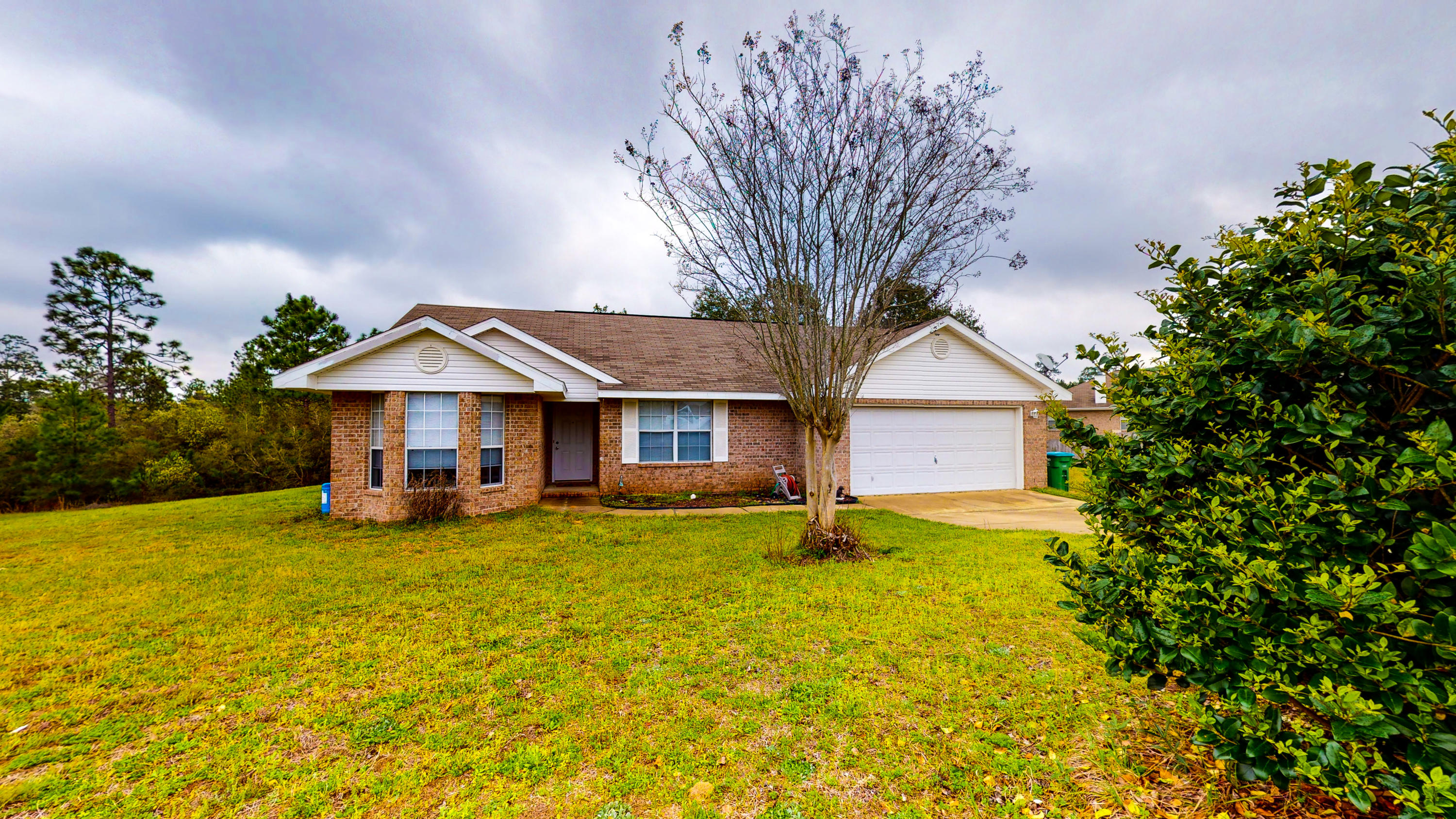 306 Shield Drive Crestview, FL 32539 - Photo 6 of 34 a front view of a house with yard and green space