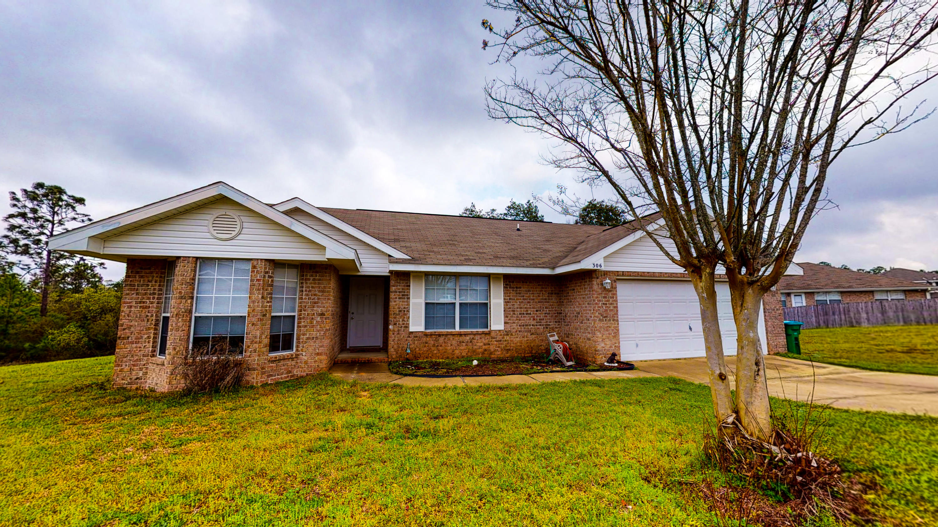 306 Shield Drive Crestview, FL 32539 - Photo 8 of 34 a backyard of a house with yard table and chairs