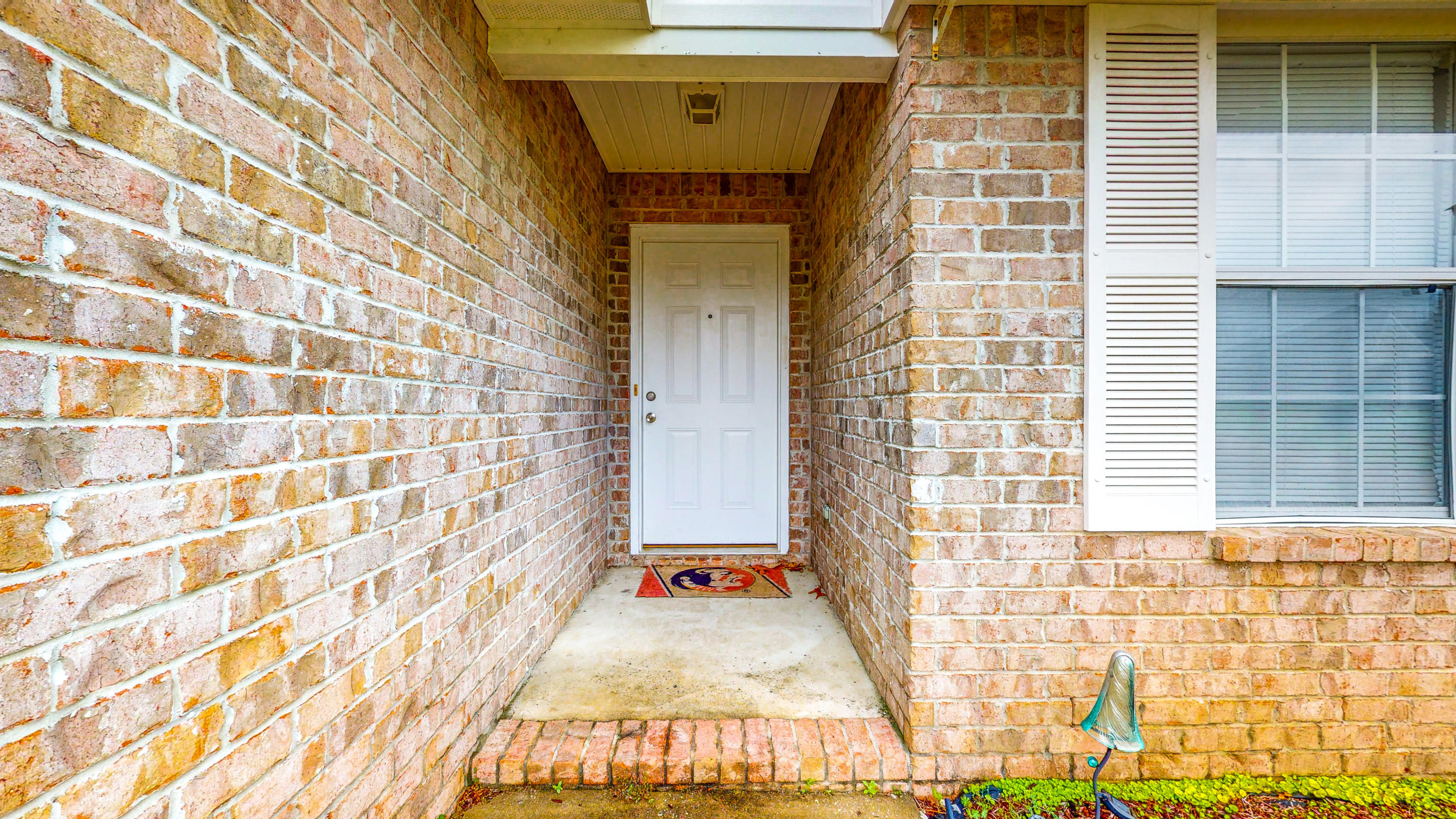 306 Shield Drive Crestview, FL 32539 - Photo 9 of 34 a view of a brick house with a small space