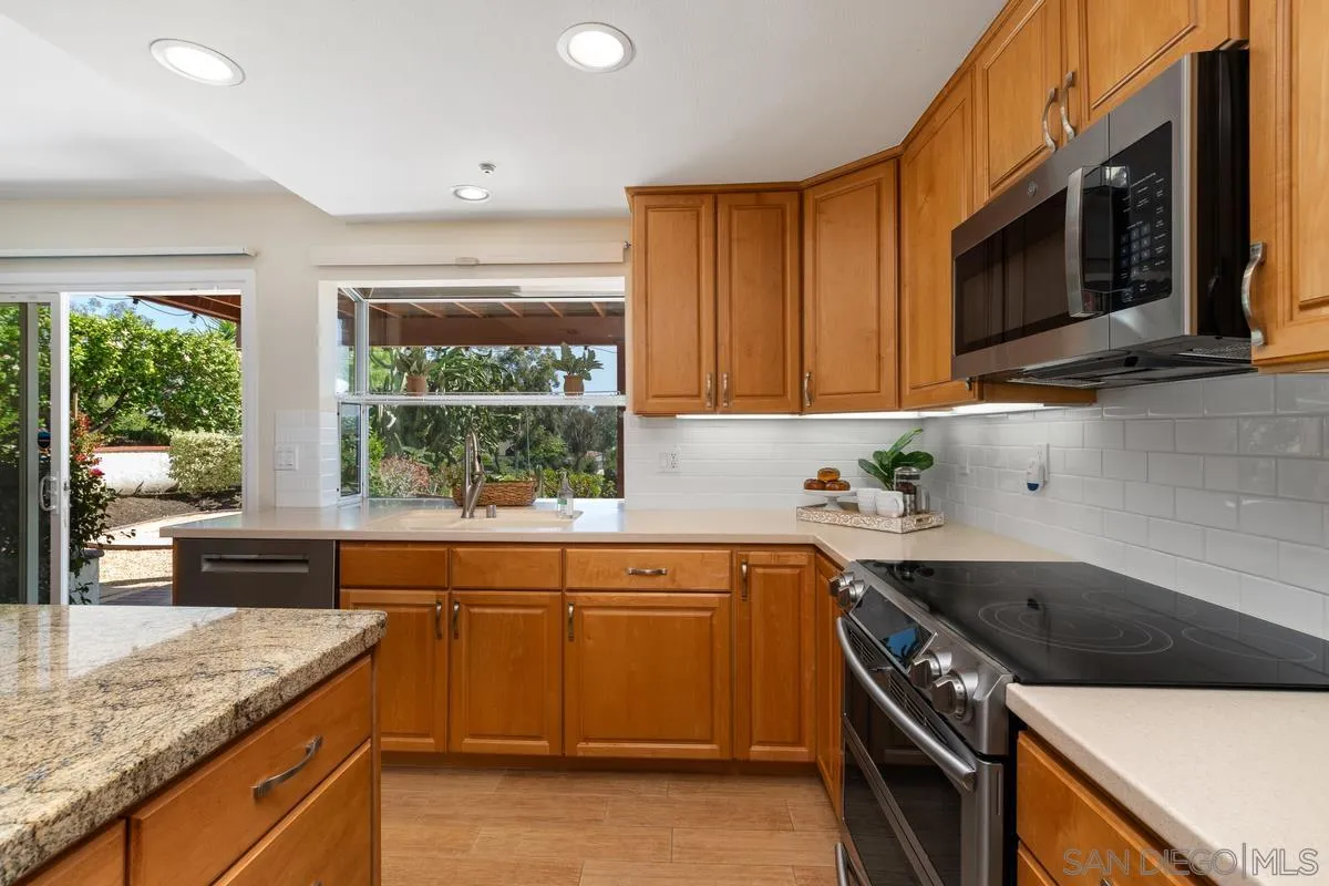 4219 Rueda Drive San Diego, CA 92124 - Photo 14 of 36 a kitchen with a sink stove top oven and cabinets