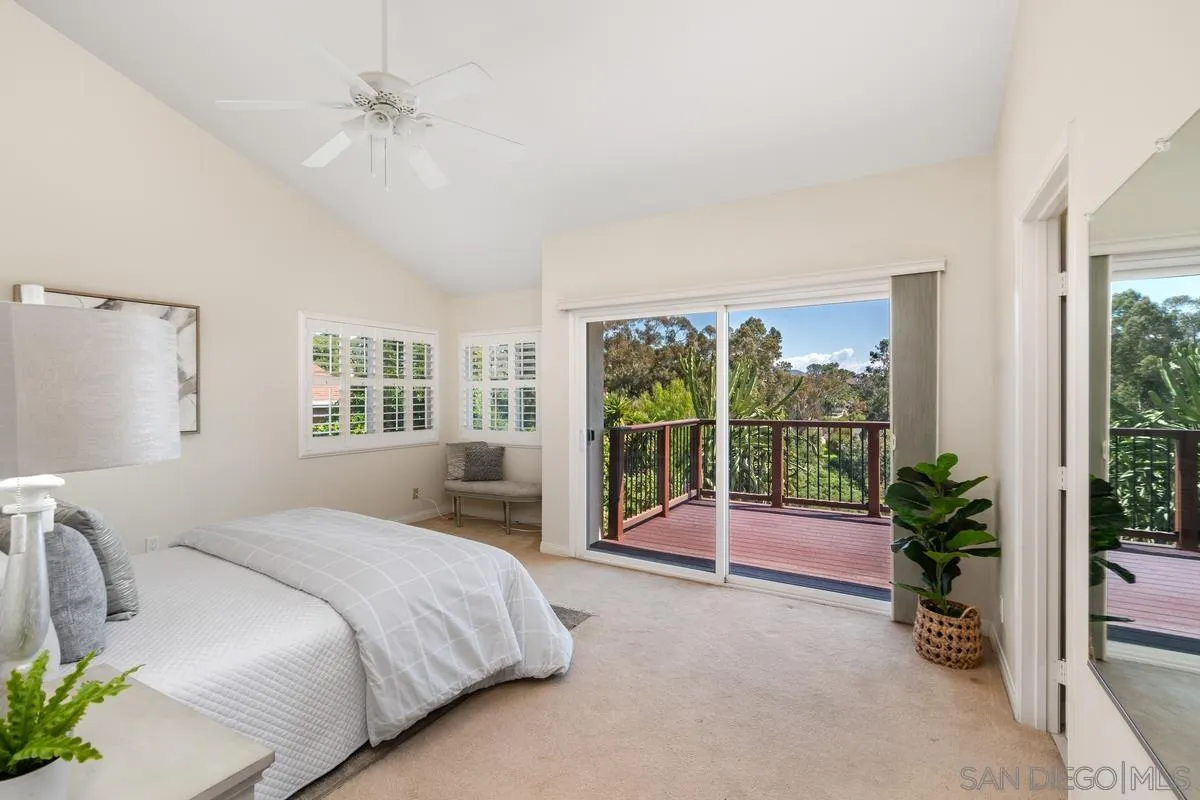 4219 Rueda Drive San Diego, CA 92124 - Photo 21 of 36 a spacious bedroom with a large bed and a chandelier