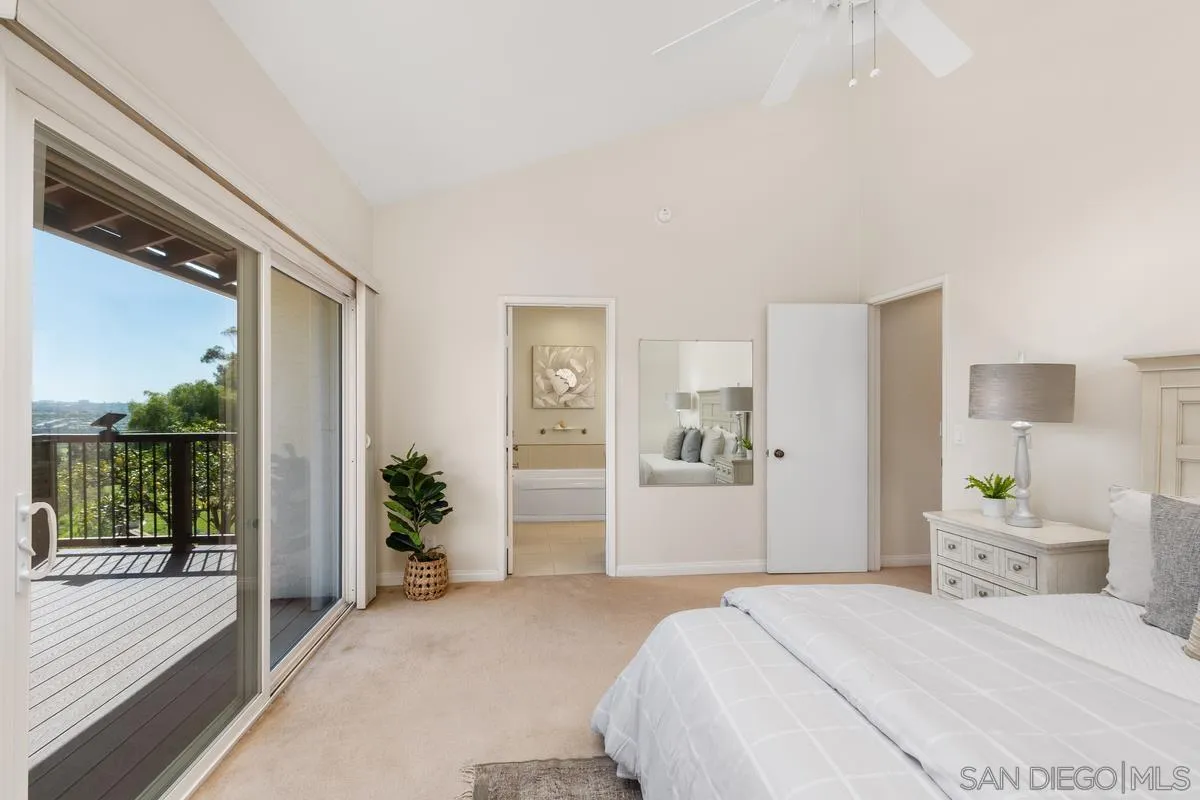 4219 Rueda Drive San Diego, CA 92124 - Photo 22 of 36 a bedroom with a large bed and a large window