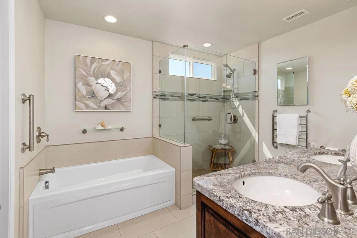 4219 Rueda Drive San Diego, CA 92124 - Photo 23 of 36 a bathroom with a granite countertop tub sink and mirror
