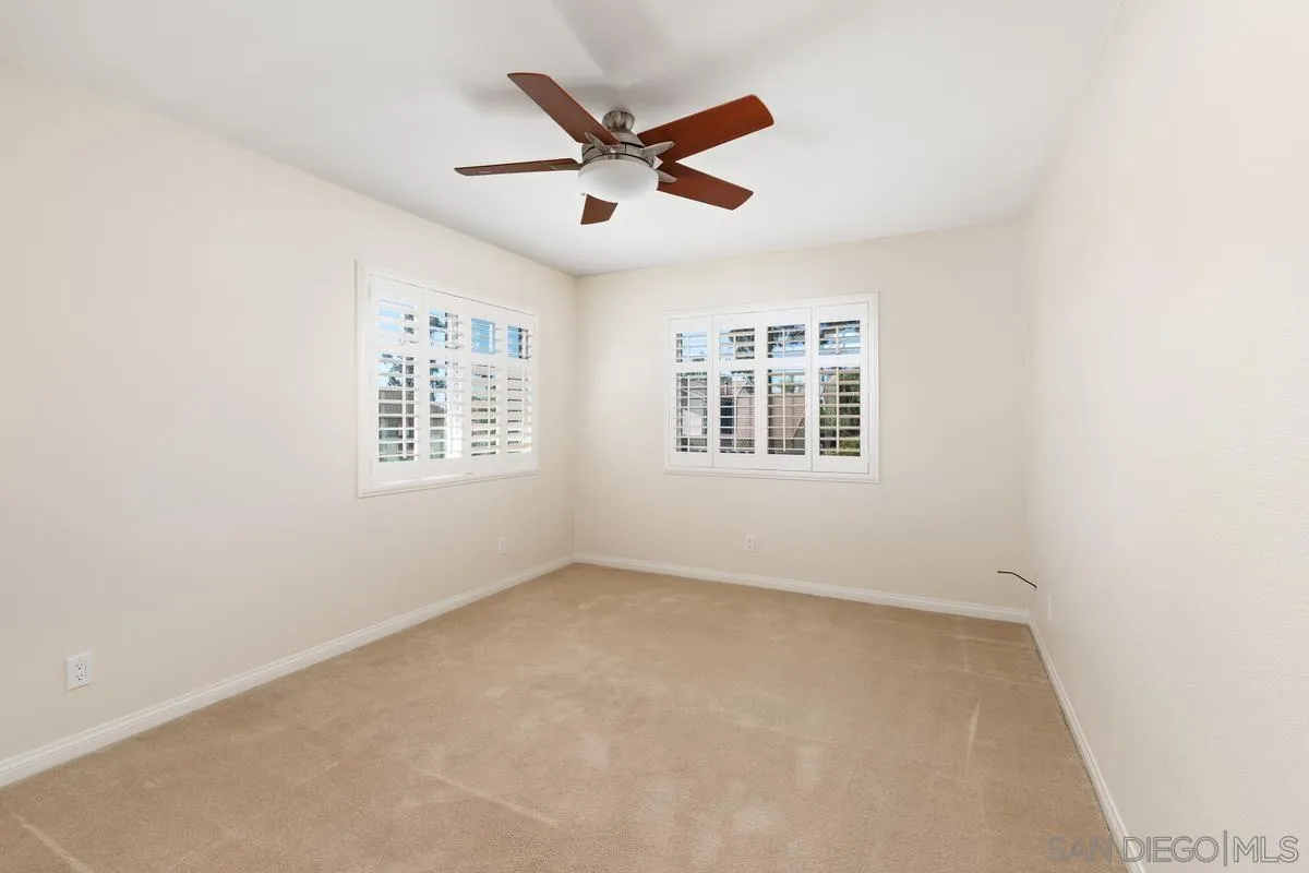 4219 Rueda Drive San Diego, CA 92124 - Photo 28 of 36 an empty room with a ceiling fan and windows