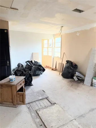 a room with a bed and a dresser