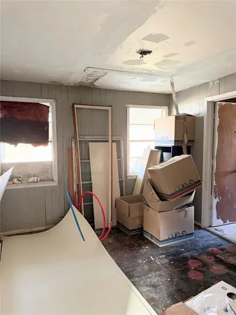 a room with a bed and a television