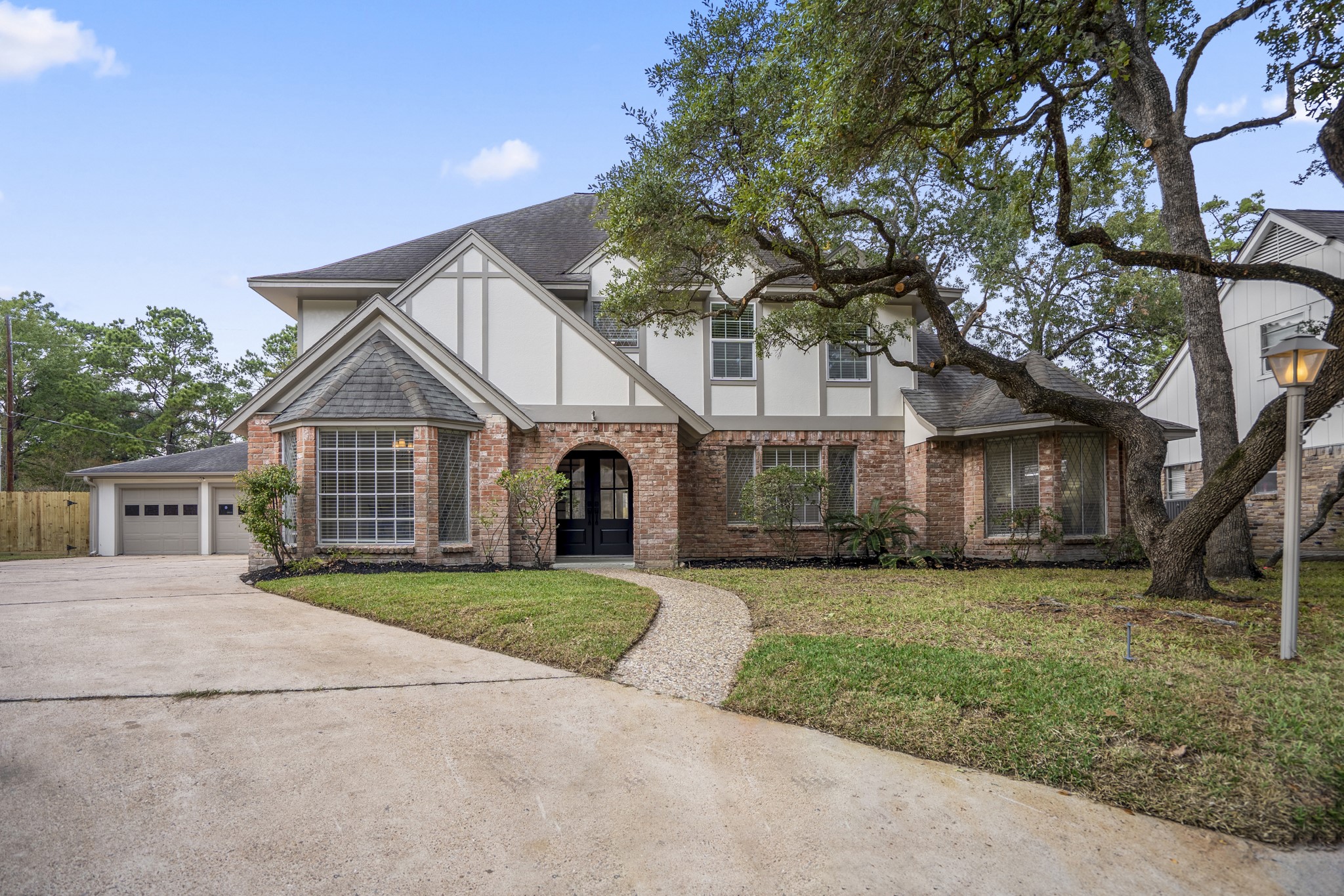 8006 Vickridge Lane Spring, TX 77379 - Photo 1 of 50 Set on a .25-acre cul-de-sac lot, this beautifully renewed Memorial Northwest home pairs classic curb appeal with mature trees and fresh exterior updates. The arched entry and wide driveway set the tone for the thoughtful style found inside.