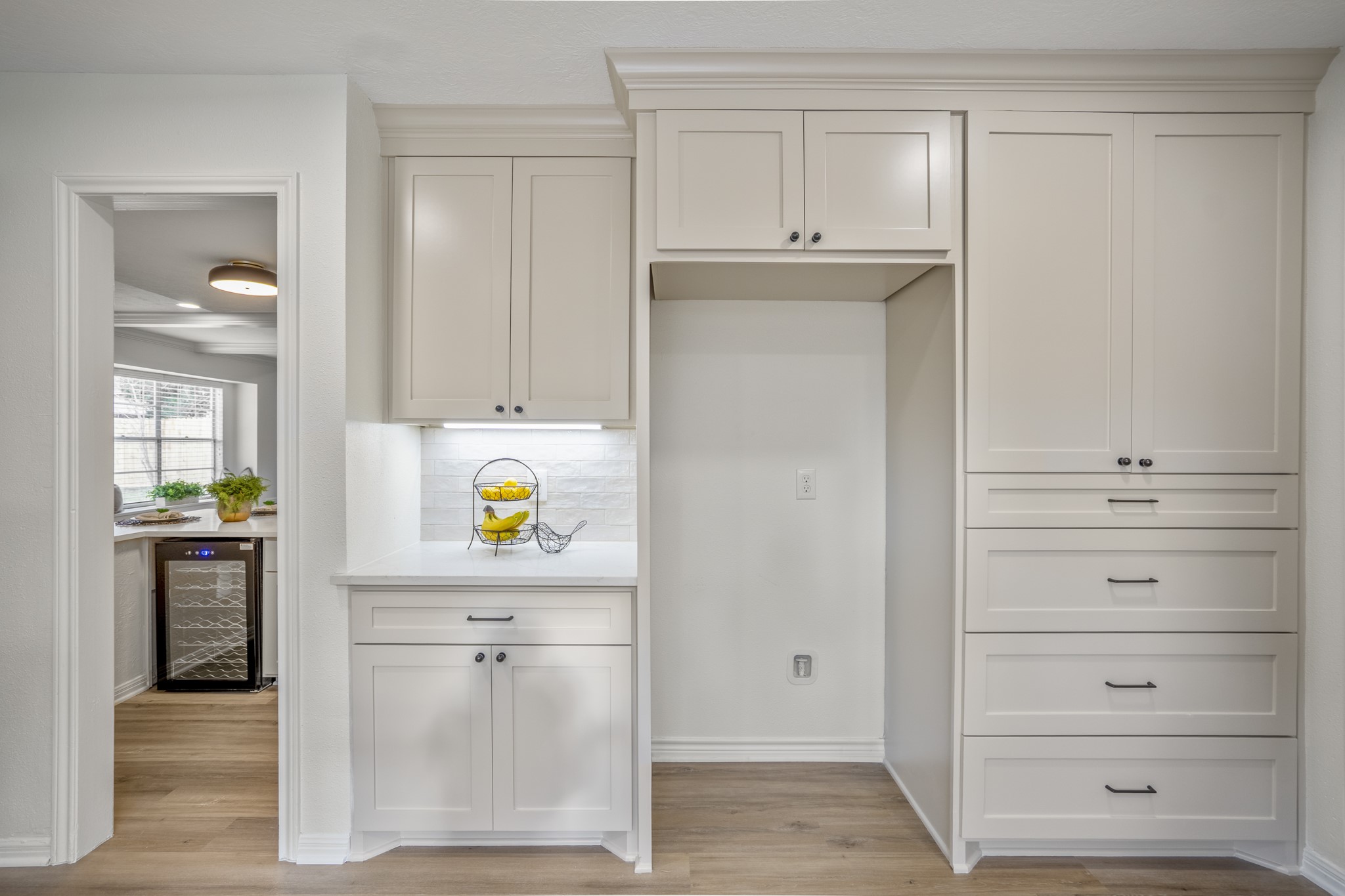 8006 Vickridge Lane Spring, TX 77379 - Photo 12 of 50 This view shows just how much thoughtful storage the kitchen offers—custom cabinetry, added drawers, and updated finishes that make the space as functional as it is beautiful. Every detail was refreshed with intention. The doorway to the left gives us a peek into the wet bar area.