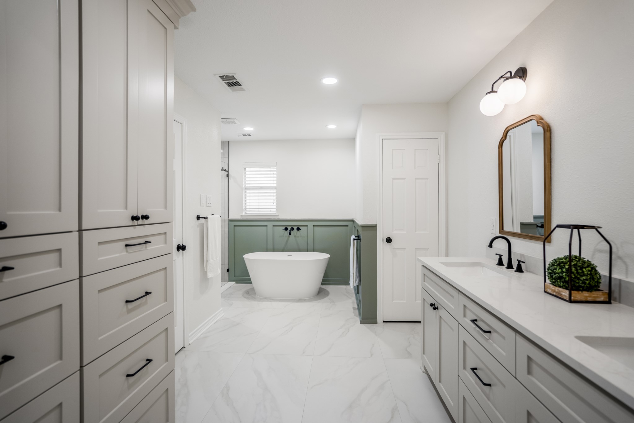 8006 Vickridge Lane Spring, TX 77379 - Photo 22 of 50 a spacious bathroom with a double vanity sink a mirror and a bathtub