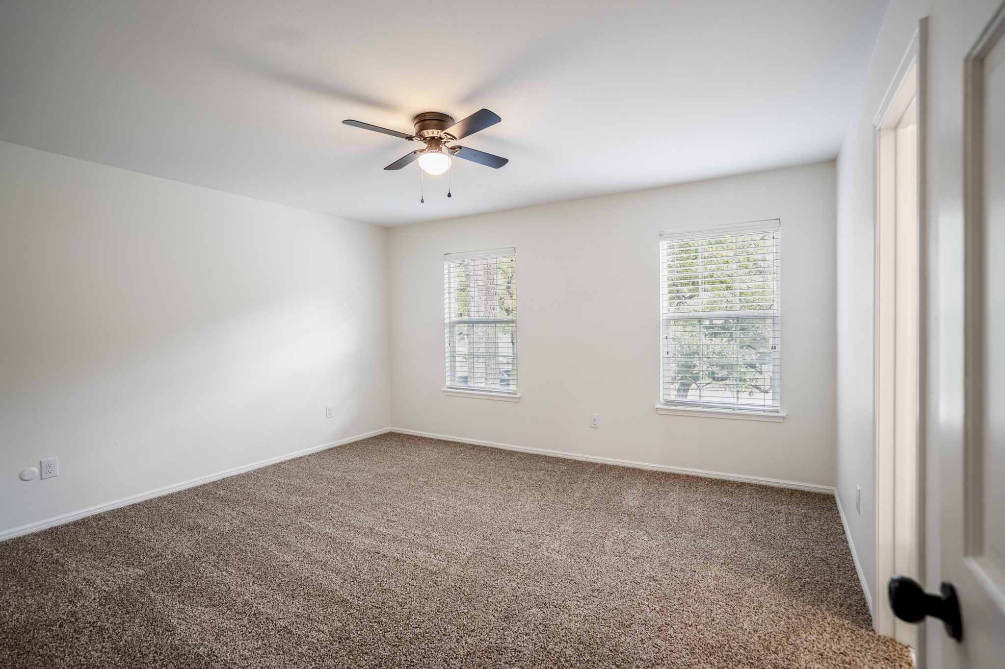 8006 Vickridge Lane Spring, TX 77379 - Photo 29 of 50 Another of the upstairs bedrooms with refreshed carpet, updated ceiling fan, and natural light that brightens the space. This room offers a walk-in closet and private en-suite bath.
