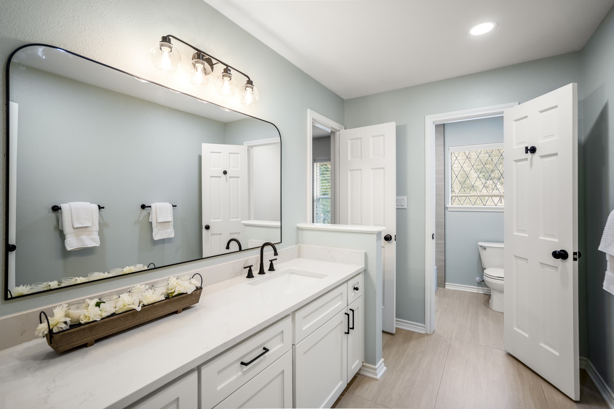 8006 Vickridge Lane Spring, TX 77379 - Photo 32 of 50 a bathroom with a double vanity sink and mirror with toilet