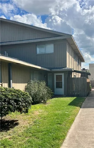 a view of a house with a yard and plants