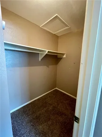 an empty room with windows and ceiling fan